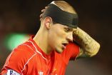 Martin-Skrtel-looks-on-with-his-head-bandaged